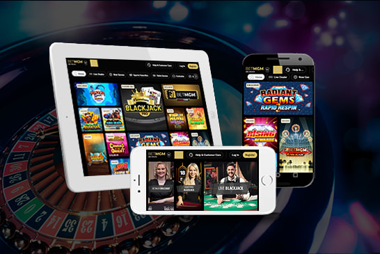 BetMGM casino platform displayed on a tablet and two mobile phones with a roulette wheel in the background.