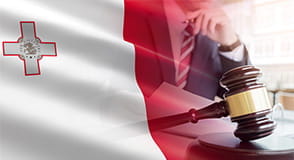 A gavel coming down while a man reads a legal document.